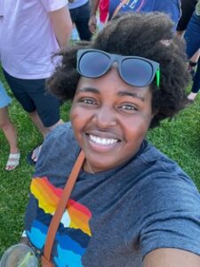 Tinotenda Maxine Tazvitya photo selfie with big smile and sunglasses.